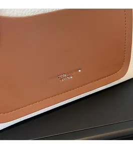 Detail showing contrast leather textures and stitching on a retro tote bag