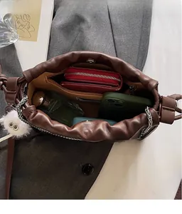 Spacious interior of brown soft leather cloud bag showing phone and wallet storage