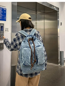 Retro washed denim backpack with drawstring closure and large capacity for travel