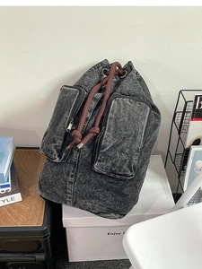Retro washed denim backpack with drawstring closure and large capacity for travel