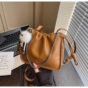 Brown pleated cloud bag with metallic chain and cute plush keychain accessory