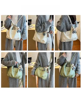 Detail view of large capacity PU leather tote in white and bean green with cute bear charm