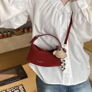 Fashionable burgundy semicircular leather crossbody bag with teddy bear charm and gold lock