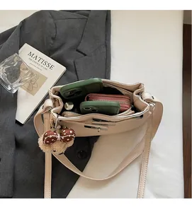 Interior view of beige leather shoulder bag showing spacious storage for phones and wallet