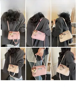 Detail shots of minimalist rectangular shoulder bags with plush bear charms and metal locks