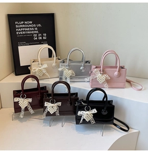 Detailed view of structured mini crossbody bags in six colors with pearl heart charms