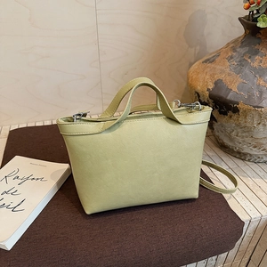 Detail view of sage green tote bag with silver hardware and adjustable shoulder strap