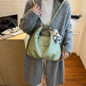 Light green leather tote bag with lychee texture and cute bear pendant accessory