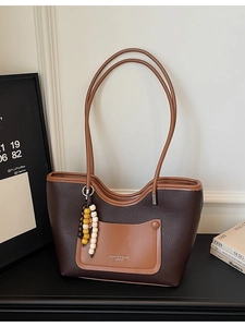Vintage textured contrast tote bag in dark brown with a tassel charm and top handles