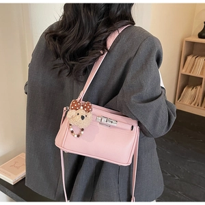 Pink lychee leather shoulder bag with silver lock and cute plush bear charm detail