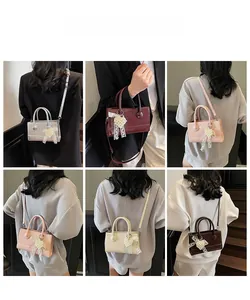 Collage of chic crossbody bags in five colors with pearl and lace bow charms