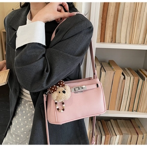 Pink lychee grain leather handbag with silver lock and polka dot bear charm