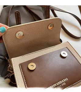 Close-up of vintage flap bag with magnetic snap buttons, canvas and leather texture