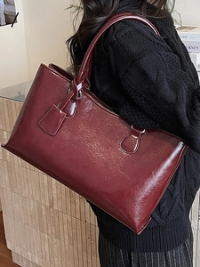 Burgundy oversized tote bag in glossy cracked leather with long handles and silver hardware