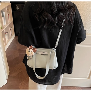 Light green faux leather crossbody bag with silver twist lock and cute bear charm