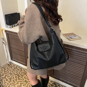 Fashionable black large capacity tote bag shown on model for daily commuting style