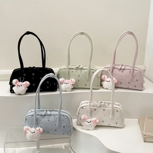 Detail view of colorful floral pattern shoulder bags with cute white bunny keychains