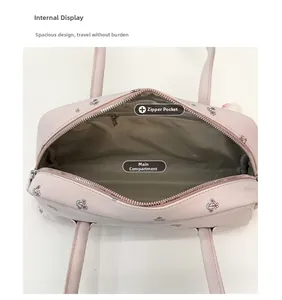 Internal view showing spacious main compartment and zipper pocket of the pink floral shoulder bag