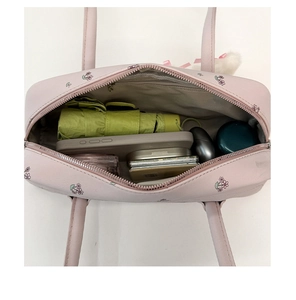 Top view of pink floral shoulder bag showing large interior capacity for daily essentials