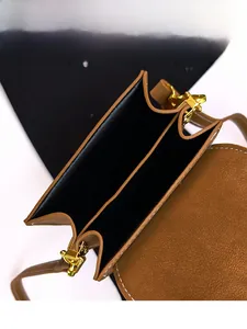 Detail view of the brown lychee leather crossbody bag with dual inner compartments