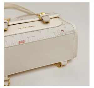 Detailed close-up showing the structured base and side pattern of this cream white PU handbag