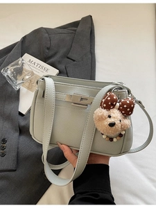 Minimalist light green lychee leather underarm bag with silver lock and plush bear charm