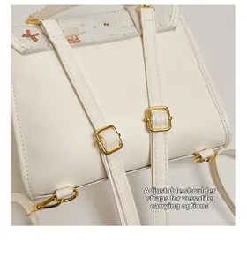 Detail of adjustable white PU leather straps and gold buckles on a cute backpack