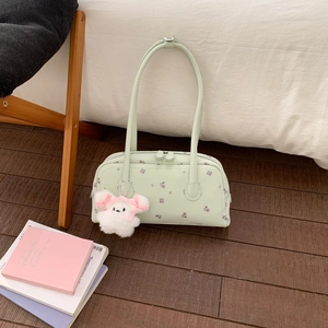 Close-up of mint green floral shoulder bag with a cute white plush cat charm detail