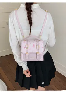 Detail of a pink school-style backpack featuring sweet bear and strawberry cartoon prints