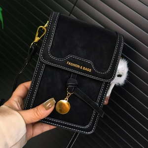 Detail of black crossbody phone bag with contrast stitching and golden hardware