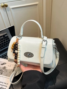 Chic white retro square handbag with metallic rotary lock and beaded fringe charm