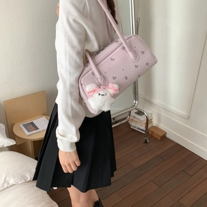 Detail of lavender shoulder bag with floral print and a cute plush rabbit pendant