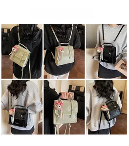 Detail of trendy glossy leather backpack for women with plush charm and logo print