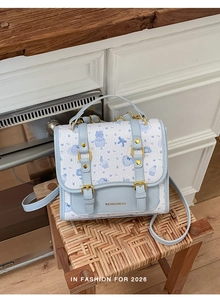 Blue cartoon cat pattern handbag with double buckles and golden hardware details