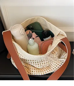 Internal view of beige woven tote bag filled with daily essentials showing large capacity