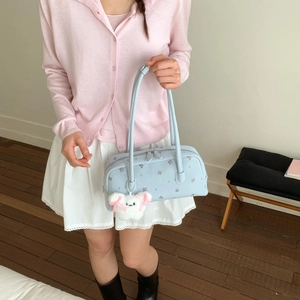 Detail of light blue floral barrel bag with a cute white plush bunny charm