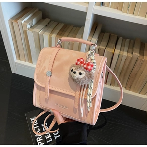 Pink PU leather vintage backpack detail featuring matte finish and plush bear pendant