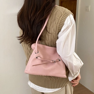 Pink leather tote bag with pleated details shown in a lifestyle shoulder carry view