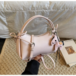 Pink minimalist leather handbag featuring silver hardware and a matching horse charm detail