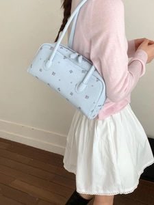 Light blue faux leather shoulder bag with red floral print and dual zipper closure