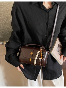 Retro dark brown crossbody bag with glossy patent finish and beaded tassel charm for women