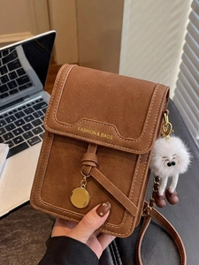 Chic brown crossbody phone bag with white stitching and cute plush doll pendant accessory