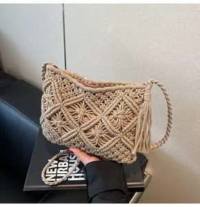 Close-up of handmade woven crossbody bag featuring diamond hollow patterns and fringe tassels