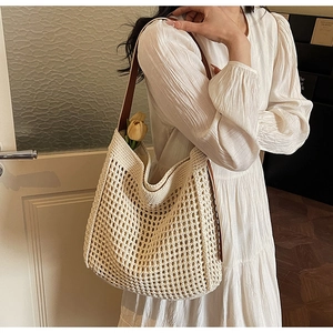Detail view of cream crochet woven tote bag with brown leather strap and inner lining