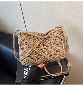 Macro shot of hand-woven macrame crossbody bag with tassel details and zipper closure
