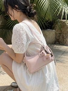 Minimalist soft pink crossbody handbag with horse charm and detachable strap