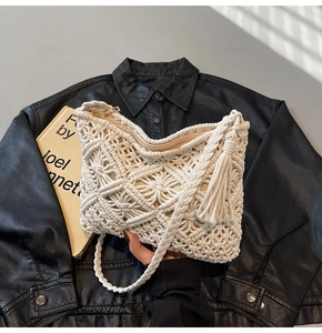 Detail of hand-woven bohemian crossbody bag with intricate crochet floral patterns and tassels