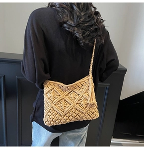 Detail of handmade macrame shoulder bag showing geometric texture and tassel fringe