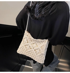 Detail view of cream woven crossbody bag featuring intricate crochet patterns and side tassel