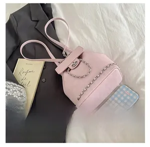 Detail view showing capacity of pink bucket backpack with silver chain and metal buckle